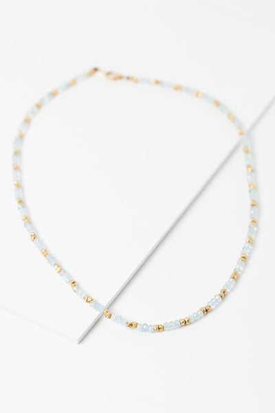 Flat lay view of Aquamarine and gold beaded necklace by Alison Jefferies for J'Adorn Designs jewelry