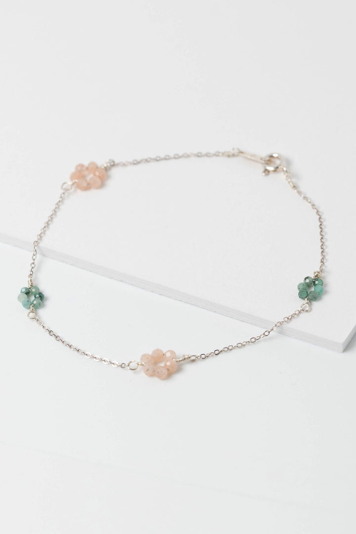 Delicate pink and green "daisy chain" sterling silver link bracelet with emerald and peach moonstone flowers on a dainty silver chain.