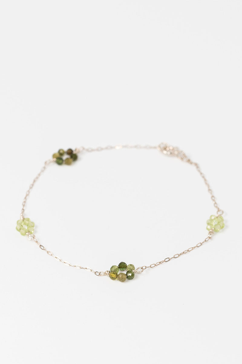 Sterling siliver "daisy chain" link bracelet with green tourmaline and peridot gemstone flowers on a dainty sterling silver chain.
