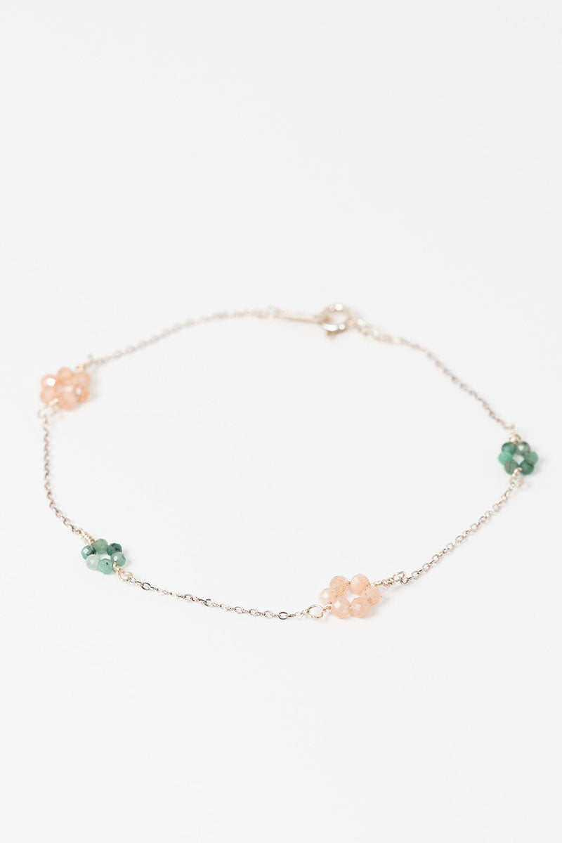 Delicate pink and green "daisy chain" sterling silver link bracelet with emerald and peach moonstone flowers on a dainty silver chain.