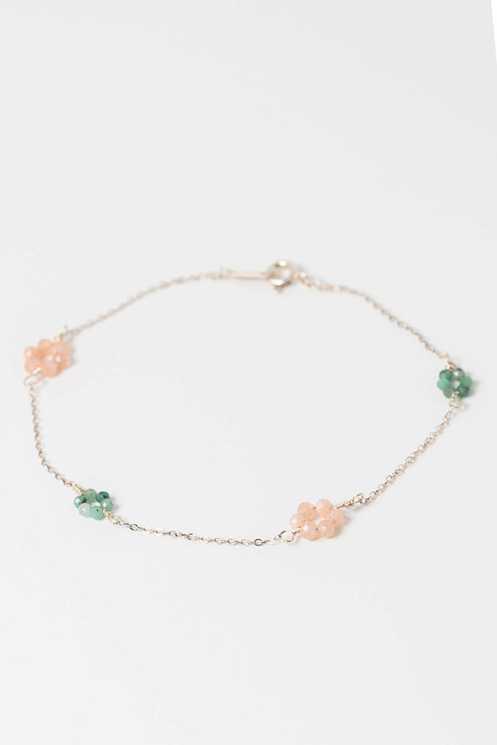 Delicate pink and green "daisy chain" sterling silver link bracelet with emerald and peach moonstone flowers on a dainty silver chain.