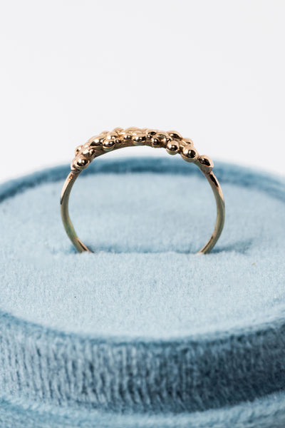 Ring profile image in a teal velvet box featuring 14k yellow gold stacking ring with organic textured top by Alison Jefferies for J'Adorn Designs jewelry
