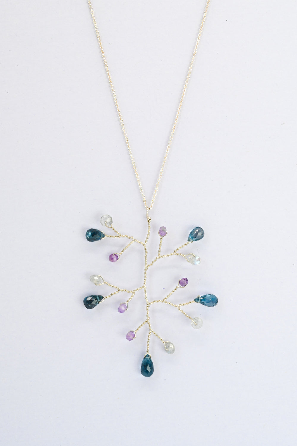 Delicate silver wire wrapped branch necklace with London blue topaz teardrops and accent beads in amethyst and labradorite, on a delicate sterling silver chain