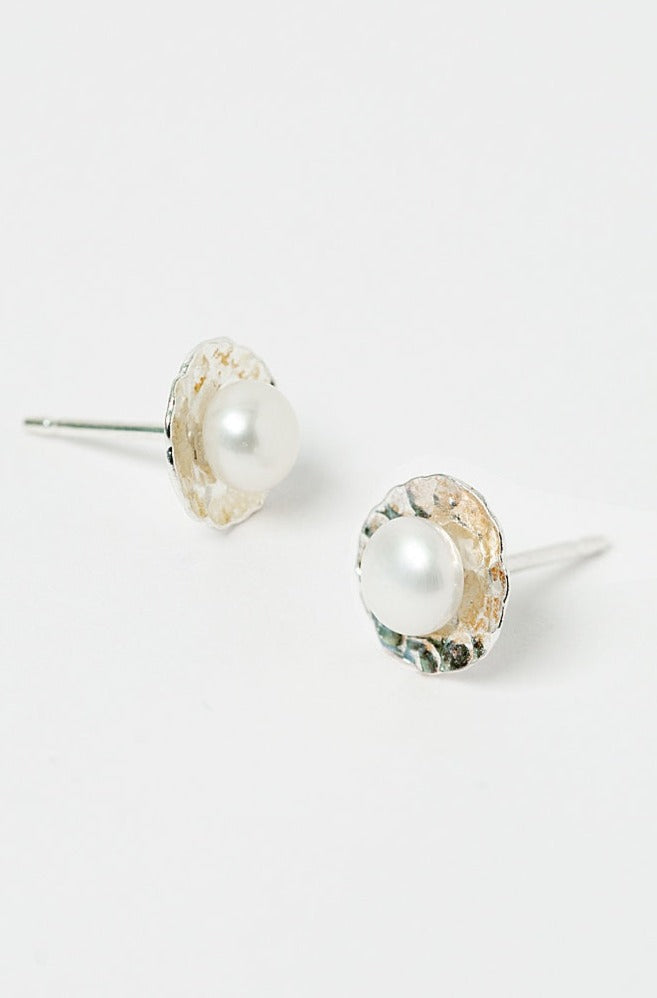 Simple sliver pearl stud earrings. Hammered silver disc stud earrings adorned with flat, round freshwater pearls. Tiny, handmade silver stud earrings by J'Adorn Designs custom jewelry and modern bridal accessories.