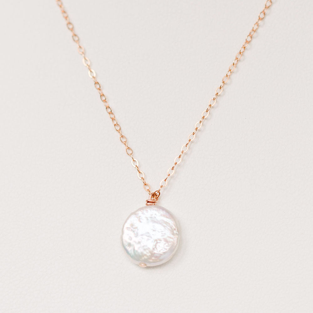 Delicate freshwater pearl pendant necklace in rose gold. One white freshwater coin pearl on a fine rose gold chain by J'Adorn Designs jewelry designer Alison Jefferies
