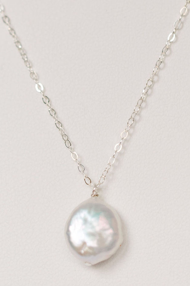 Delicate freshwater pearl pendant necklace in sterling silver. One white freshwater coin pearl on a fine silver chain by J'Adorn Designs jewelry designer Alison Jefferies