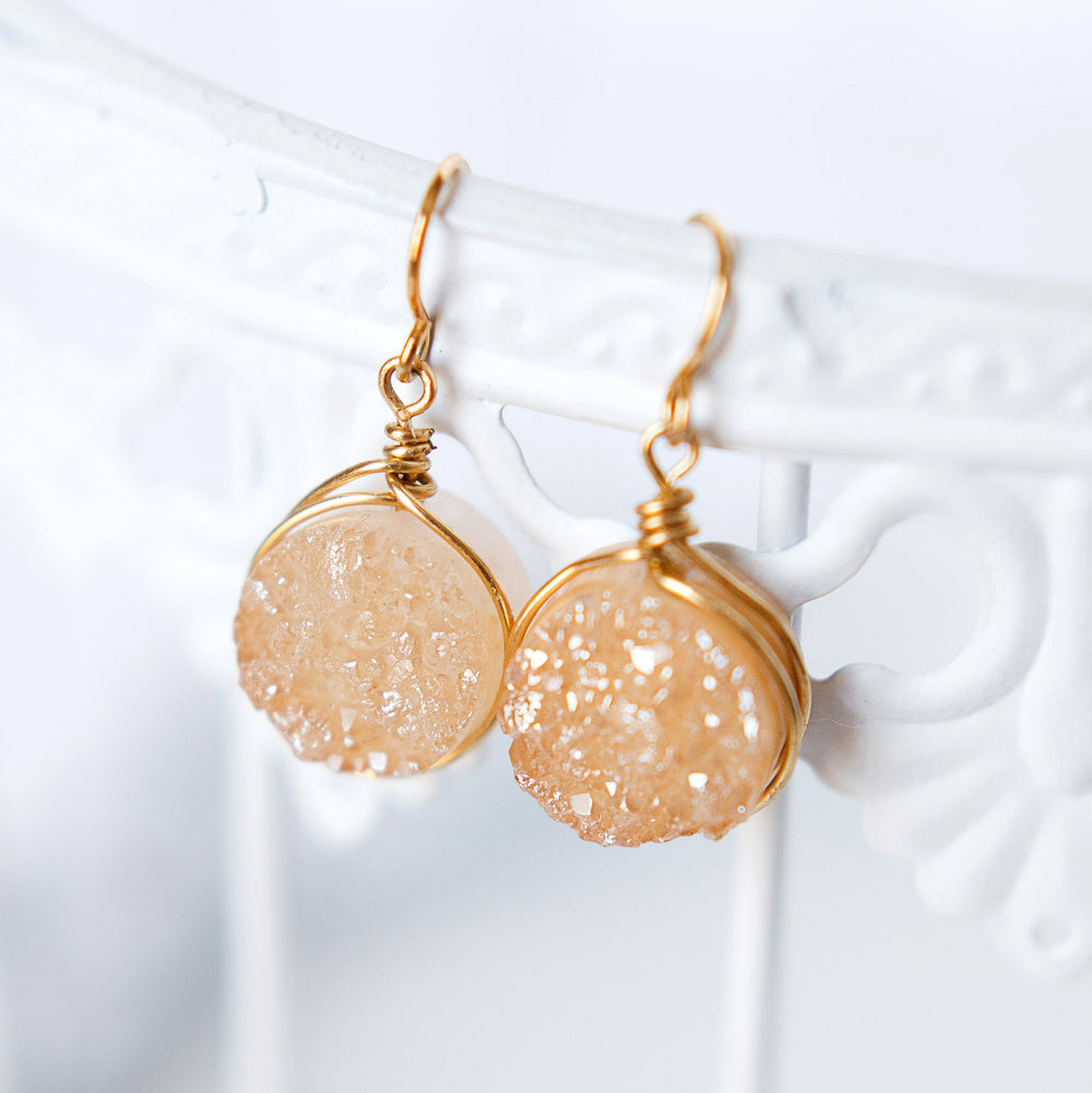 Golden champagne colored round druzy drop earrings with gold wires. Handcrafted druzy jewelry by designer Alison Jefferies of J'Adorn Designs