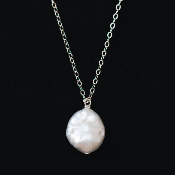 Delicate freshwater pearl pendant necklace in sterling silver. One white freshwater coin pearl on a fine silver chain by J'Adorn Designs jewelry designer Alison Jefferies