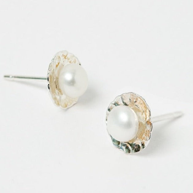 Simple sliver pearl stud earrings. Hammered silver disc stud earrings adorned with flat, round freshwater pearls. Tiny, handmade silver stud earrings by J'Adorn Designs custom jewelry and modern bridal accessories.