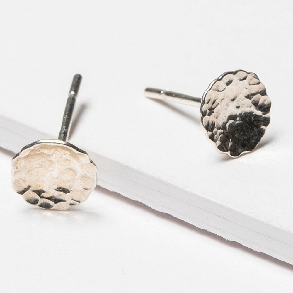 Small hammered sterling silver disc stud earrings. Artisan jewelry and luxury bridal accessories handmade in Maryland by Alison Jefferies of J'Adorn Designs.