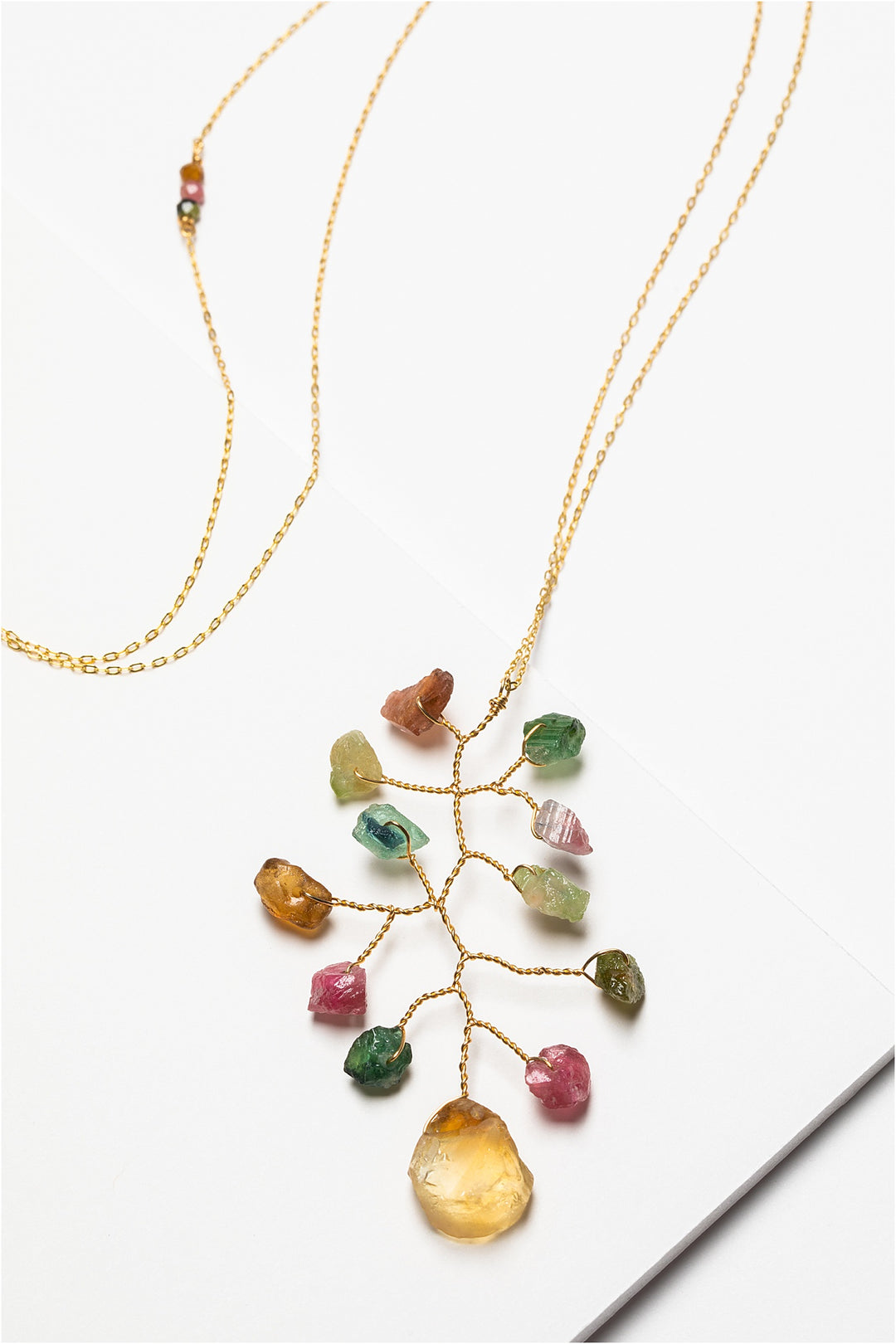 Long asymmetrical necklace with rough rainbow tourmaline and citrine gemstones in a wire wrapped branch design made by J'Adorn Designs artisan Alison Jefferies of Baltimore, MD.