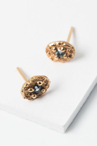 14k gold and light blue sapphires in a textured oval setting, handcrafted everyday sapphire stud earrings by Alison Jefferies for J'Adorn Designs