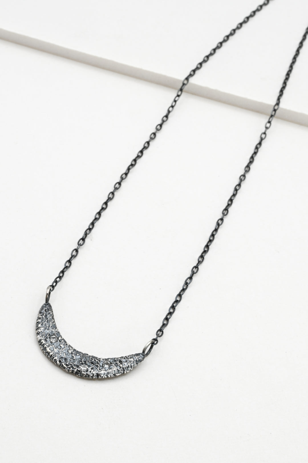 Textured oxidized silver collar necklace with three white sapphires 