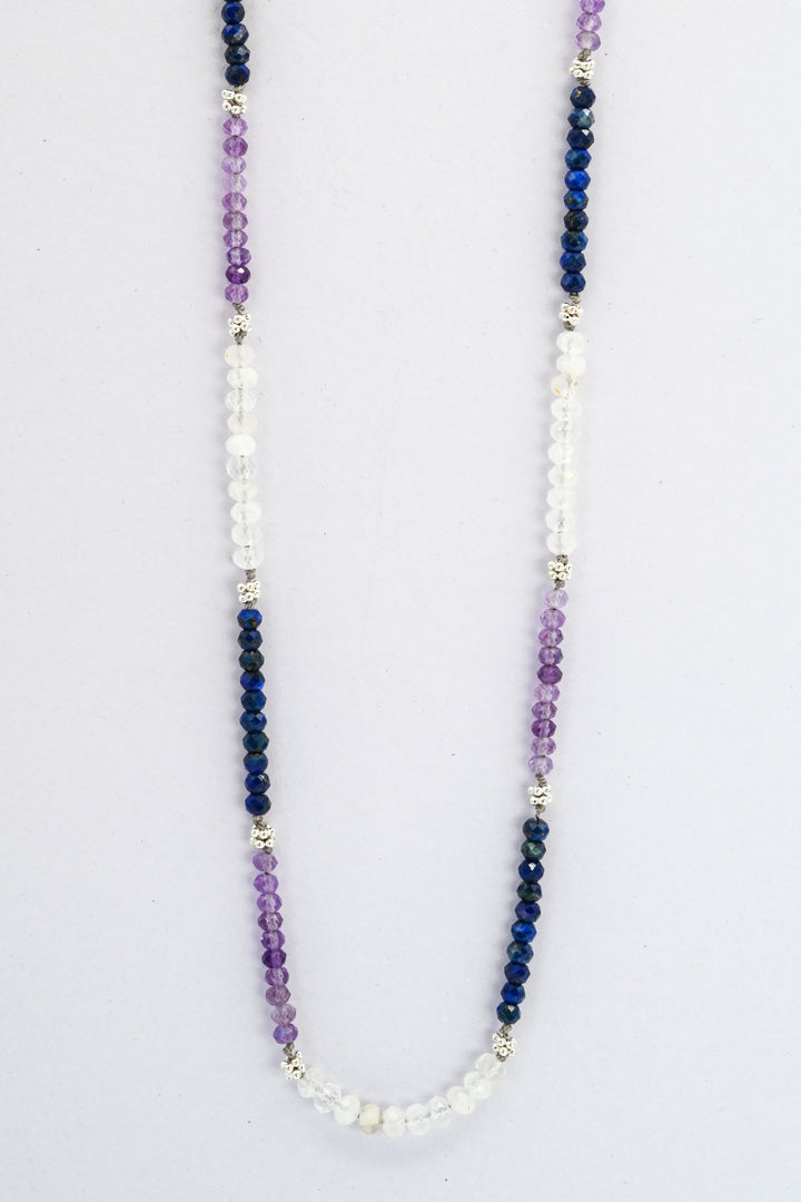 Color blocked beaded gemstone necklace with sections of amethyst, sapphire, and moonstone divided by sterling silver beads