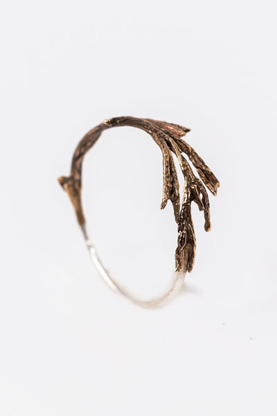 Side view of bronze and silver twig ring, handcrafted jewelry made from plants, by Alison Jefferies for J'Adorn Designs