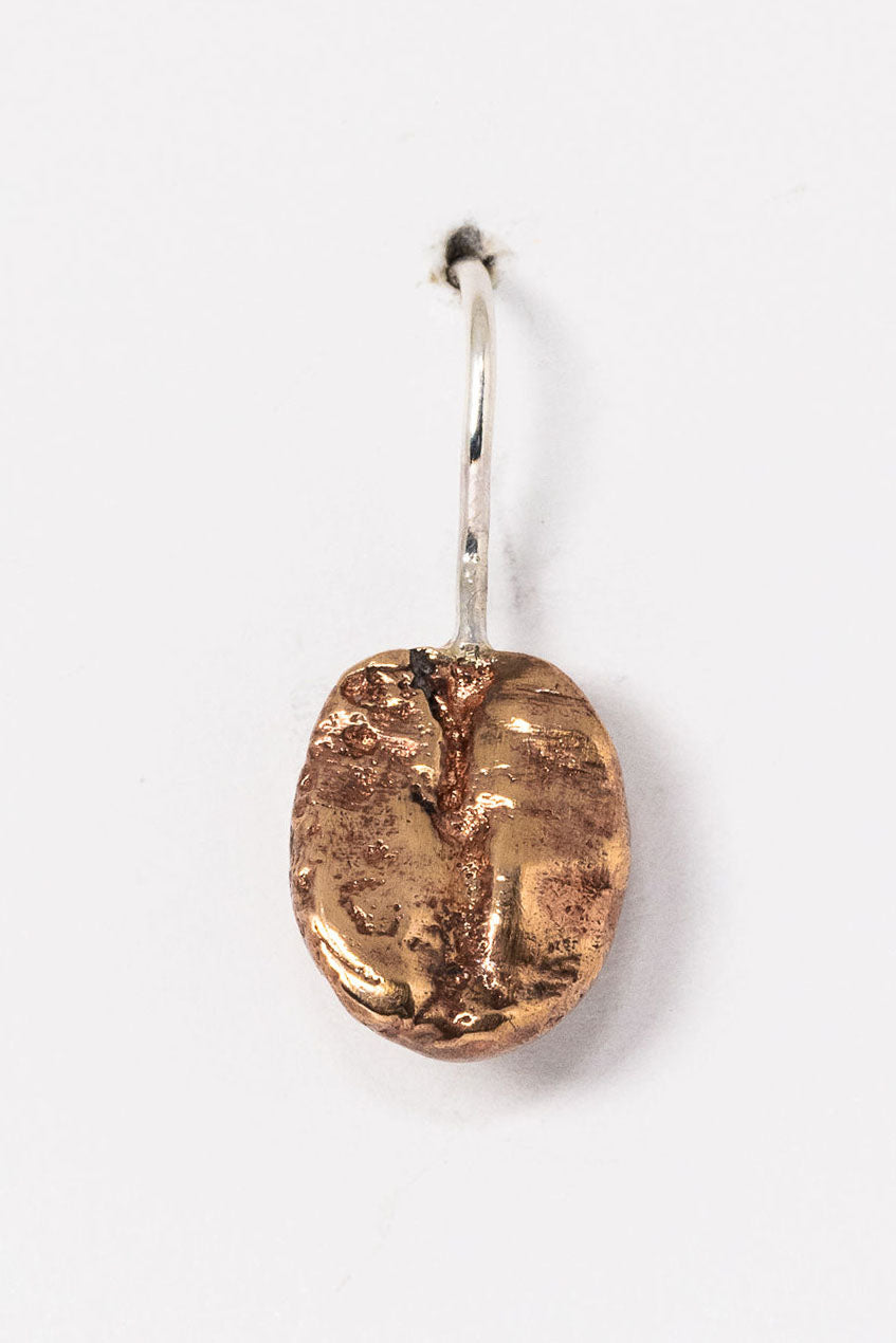 Single bronze coffee bean earring with a sterling silver hook. Unisex earring style to mix and match or wear alone. Gender inclusive jewelry by J'Adorn Designs.