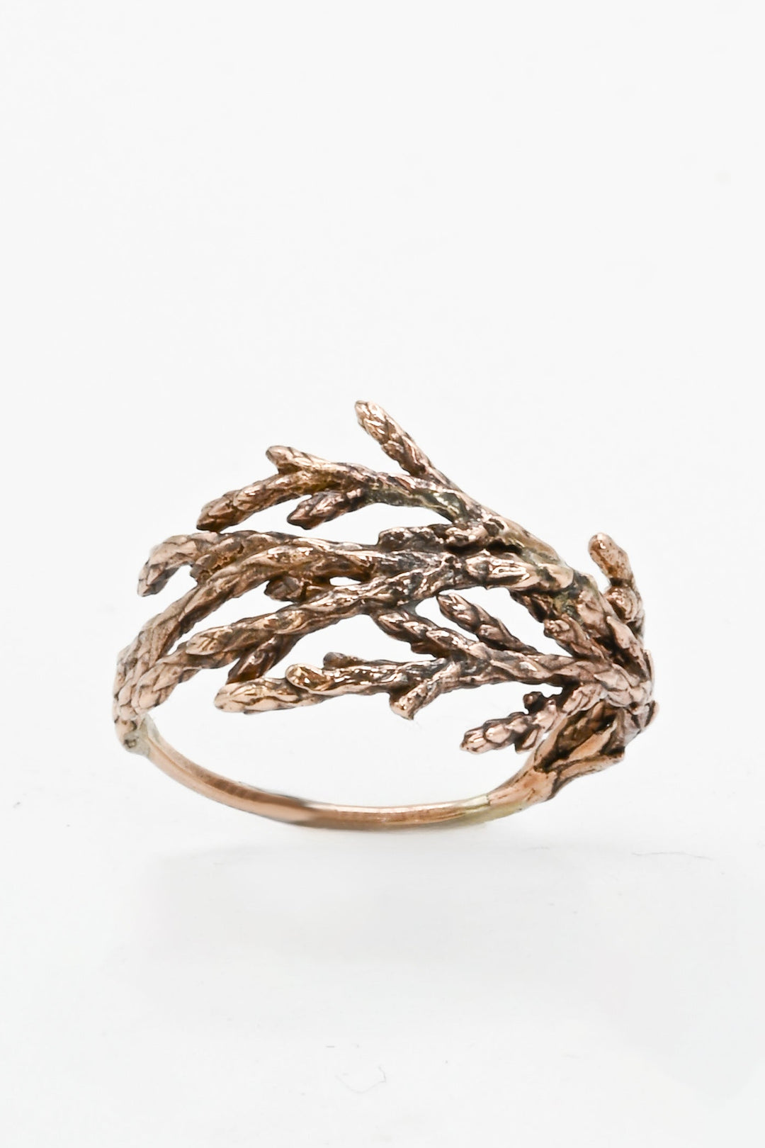 Bronze branch-shaped ring on a white background