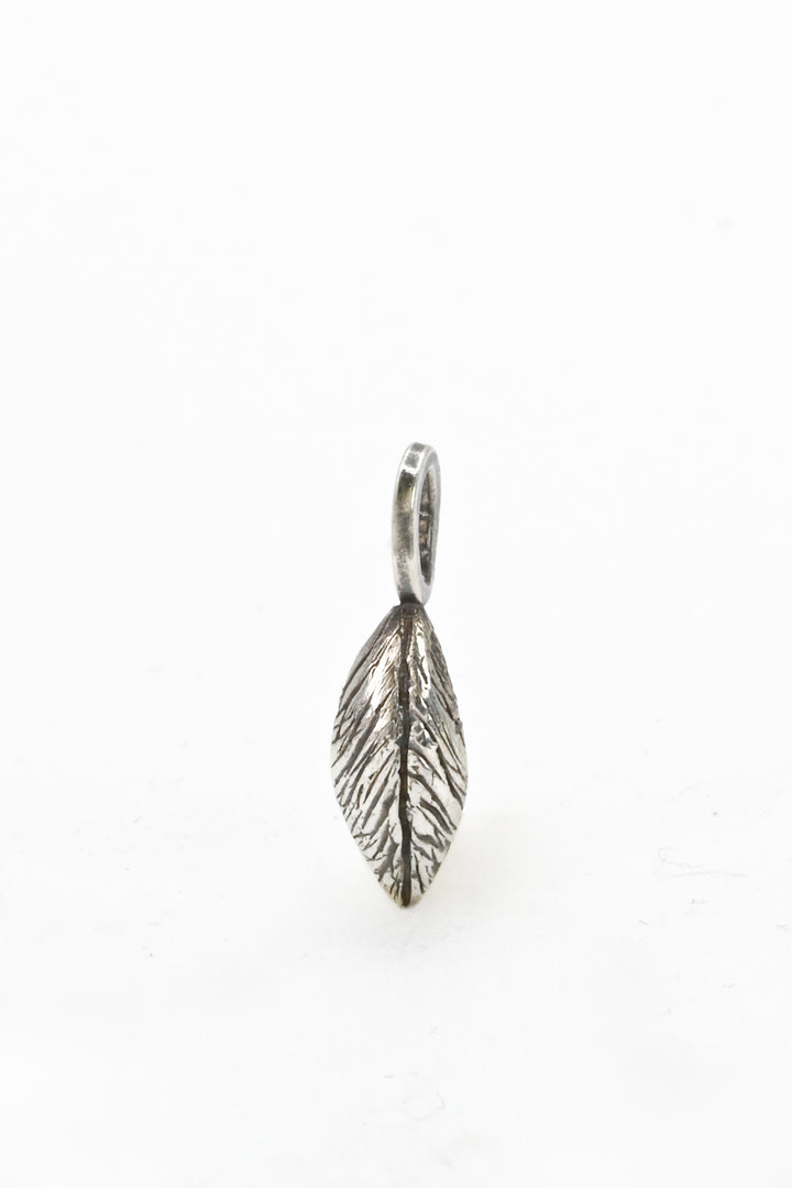 A hand-carved and cast sterling silver leaf charm or pendant by J'Adorn Designs