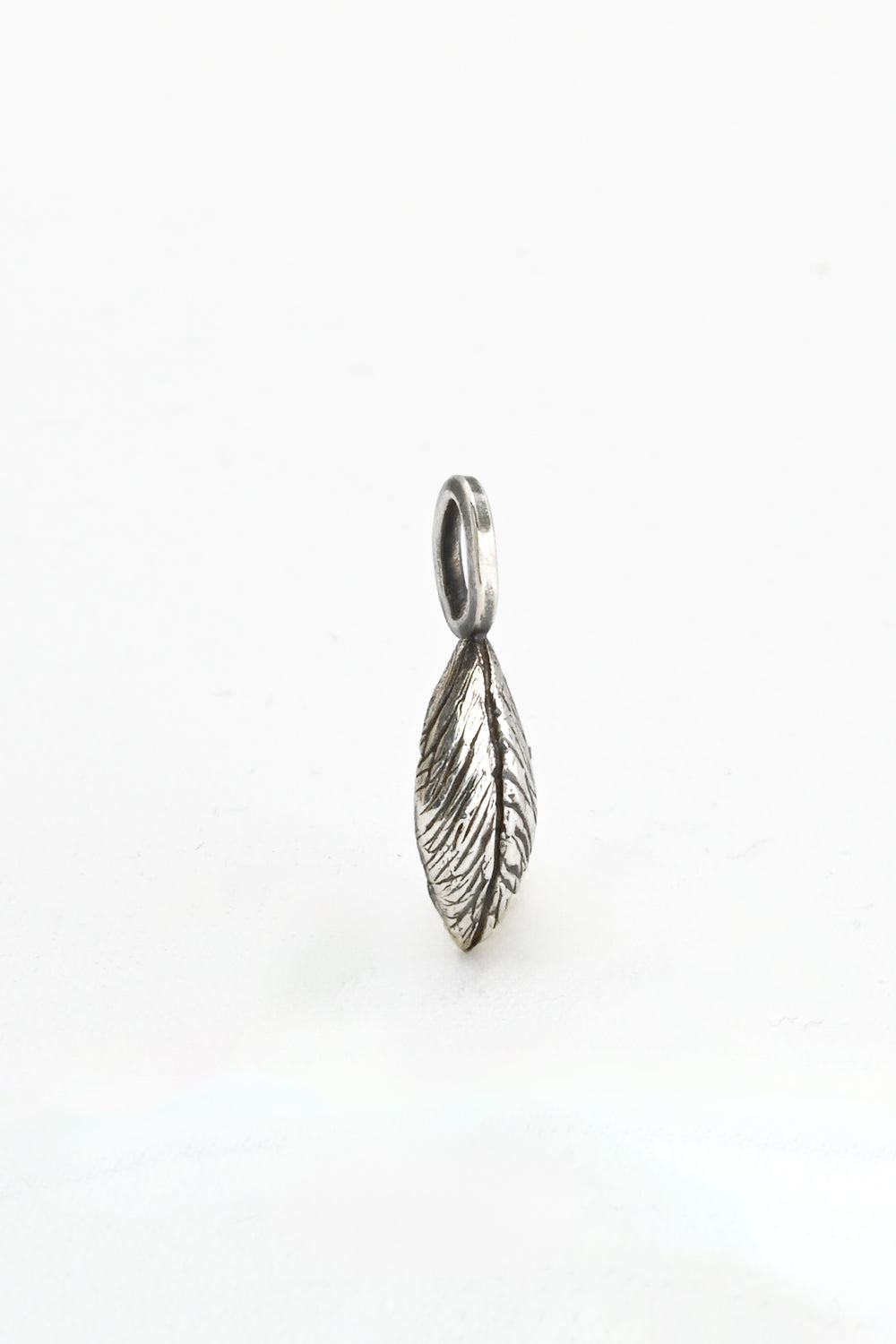 3/4 view of a hand-carved and cast sterling silver leaf charm or pendant by J'Adorn Designs