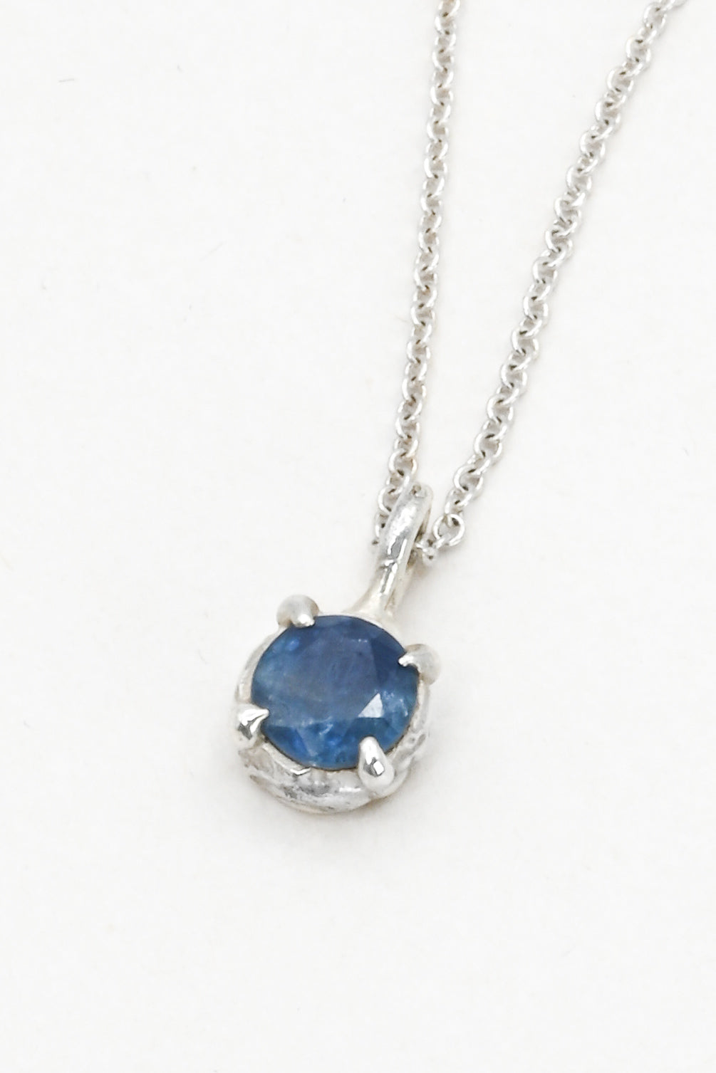 Round blue sapphire in a pronged sterling silver cast setting on a delicate silver chain by J'Adorn Designs