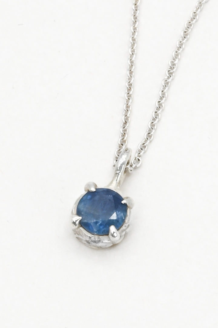 Round blue sapphire in a pronged sterling silver cast setting on a delicate silver chain by J'Adorn Designs