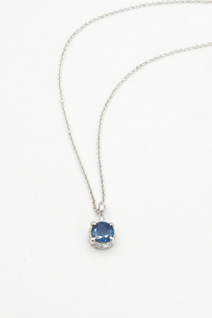 Round blue sapphire in a pronged sterling silver cast setting on a delicate silver chain by J'Adorn Designs