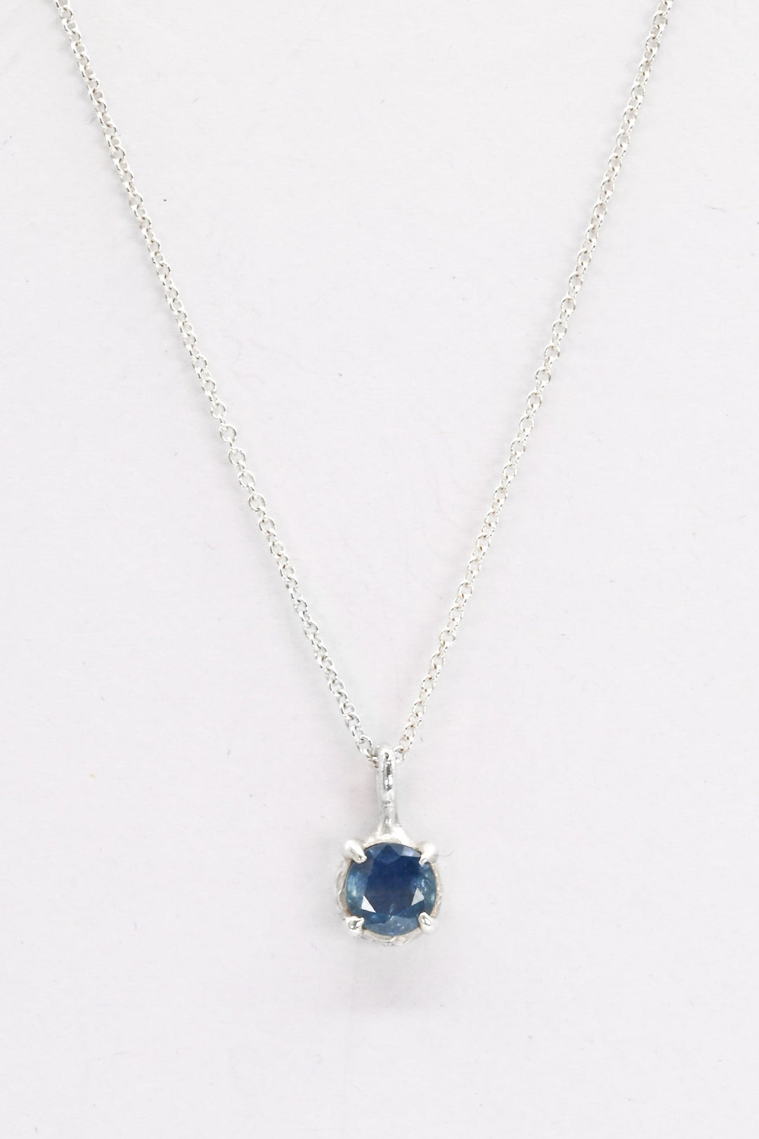 Round blue sapphire in a pronged sterling silver cast setting on a delicate silver chain by J'Adorn Designs