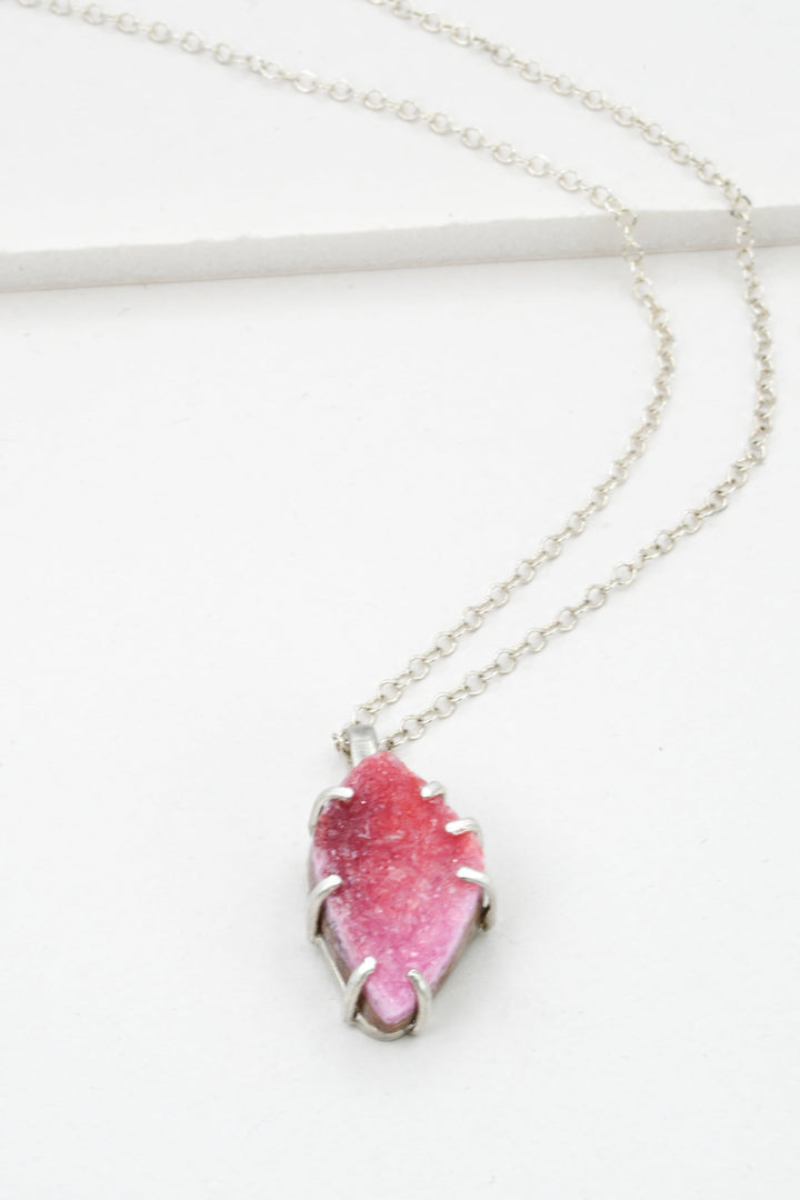 Sterling silver necklace with a pink cobaltocalcite pendant on a white background