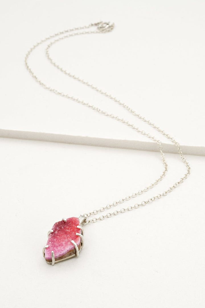 Sterling silver necklace with a pink cobaltocalcite pendant on a white background