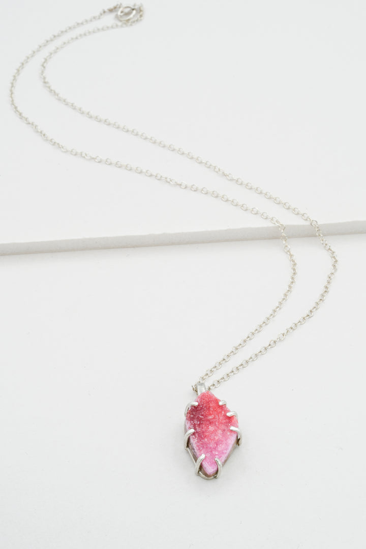 Sterling silver necklace with a pink cobaltocalcite pendant on a white background