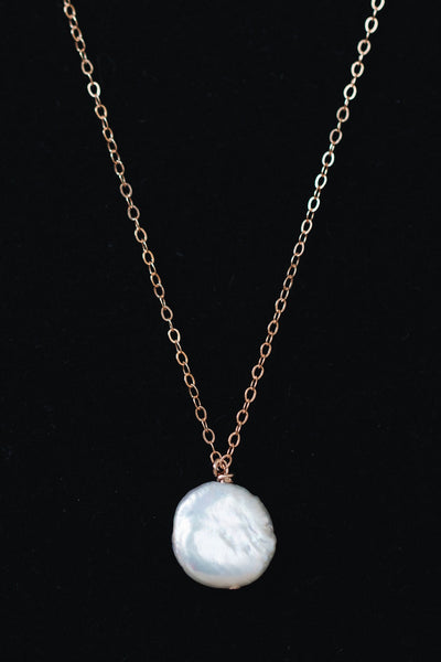 Delicate freshwater pearl pendant necklace in rose gold. One white freshwater coin pearl on a fine rose gold chain by J'Adorn Designs jewelry designer Alison Jefferies
