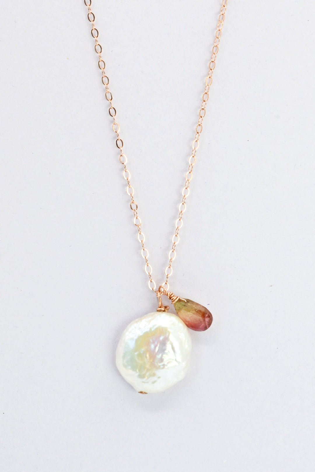 Delicate rose gold charm necklace with a white freshwater coin pearl and small watermelon tourmaline teardrop