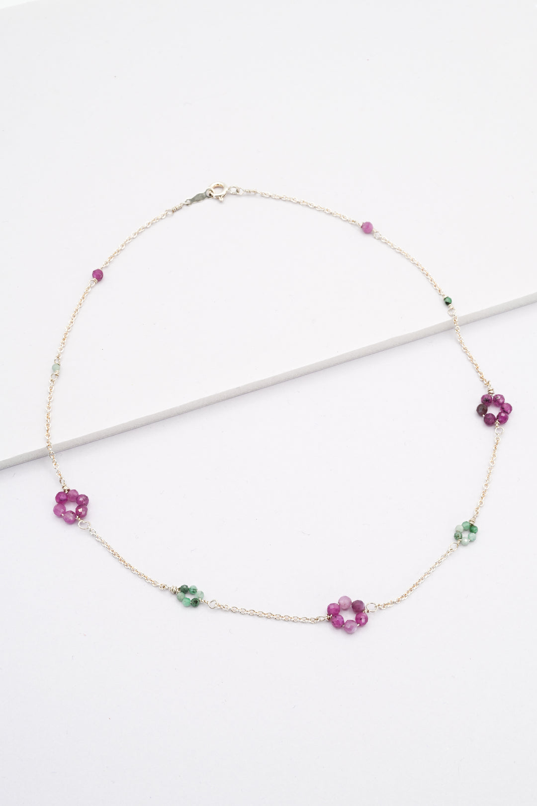 Silver daisy chain necklace with emerald and ruby flowers, and delicate sterling silver chain. 
