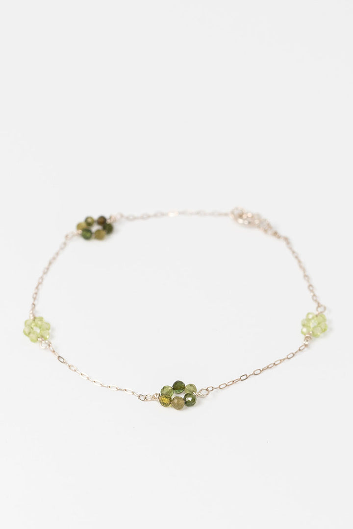 Sterling siliver "daisy chain" link bracelet with green tourmaline and peridot gemstone flowers on a dainty sterling silver chain.
