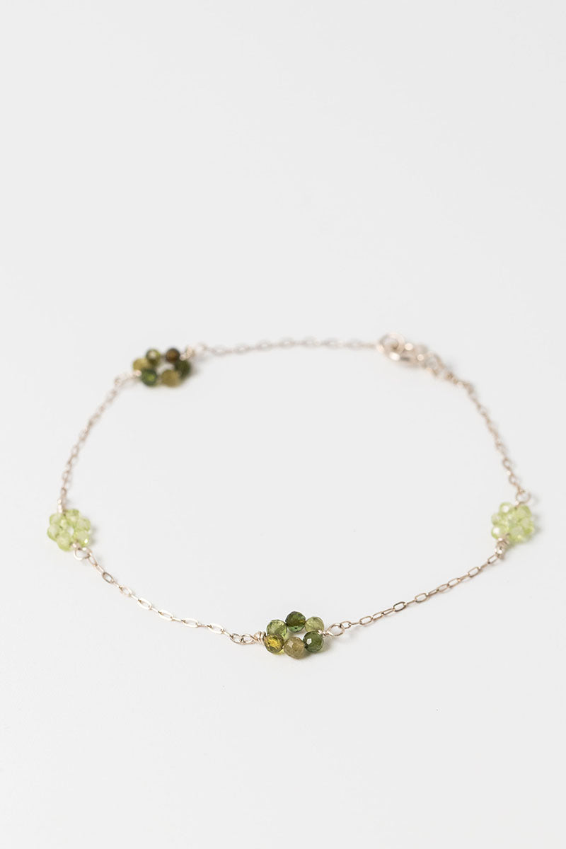 Sterling siliver "daisy chain" link bracelet with green tourmaline and peridot gemstone flowers on a dainty sterling silver chain.
