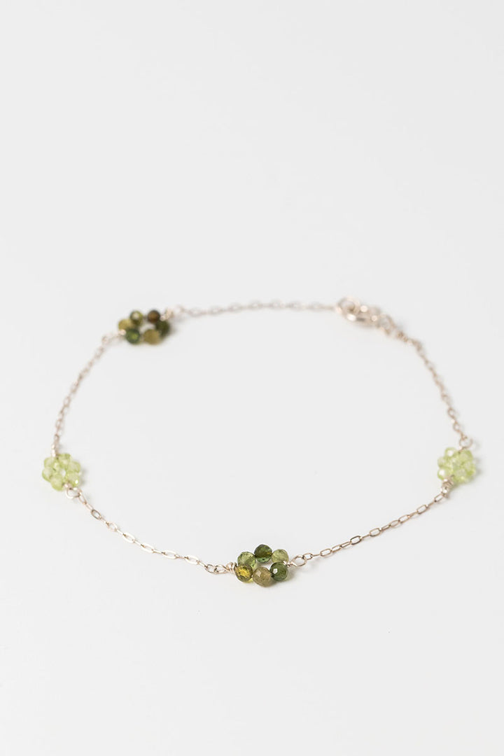 Sterling siliver "daisy chain" link bracelet with green tourmaline and peridot gemstone flowers on a dainty sterling silver chain.