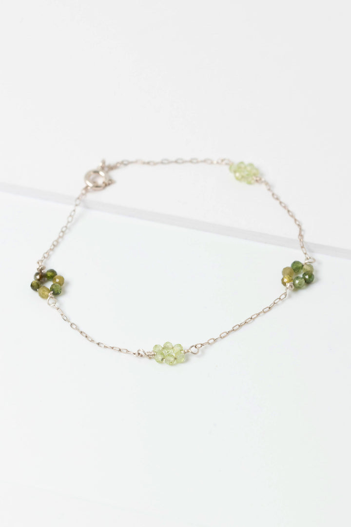 Sterling siliver "daisy chain" link bracelet with green tourmaline and peridot gemstone flowers on a dainty sterling silver chain.