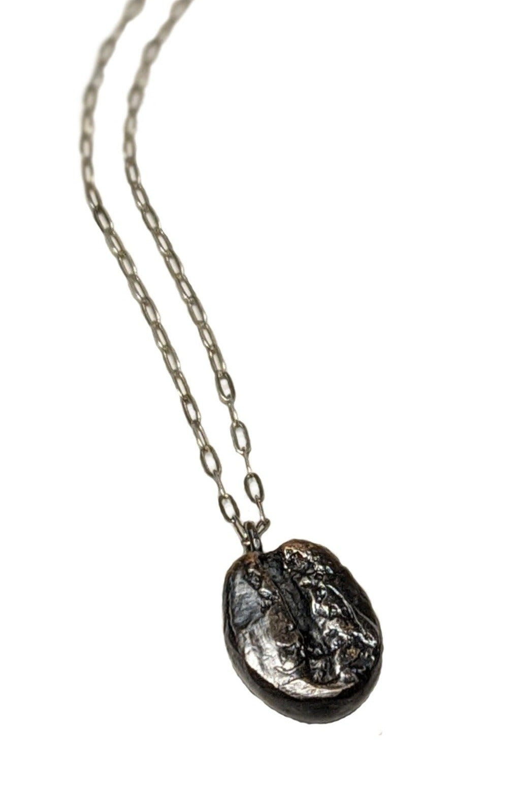Dark roast coffee bean necklace with a delicate sterling silver chain. Coffee lover's jewelry gift by J'Adorn Designs artist Alison Jefferies
