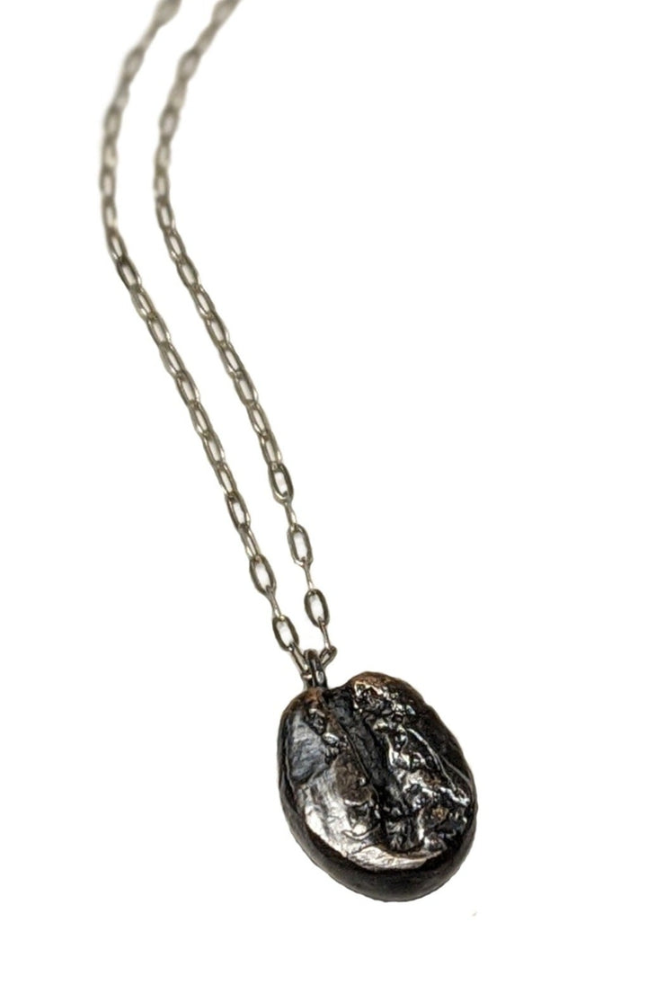 Dark roast coffee bean necklace with a delicate sterling silver chain. Coffee lover's jewelry gift by J'Adorn Designs artist Alison Jefferies