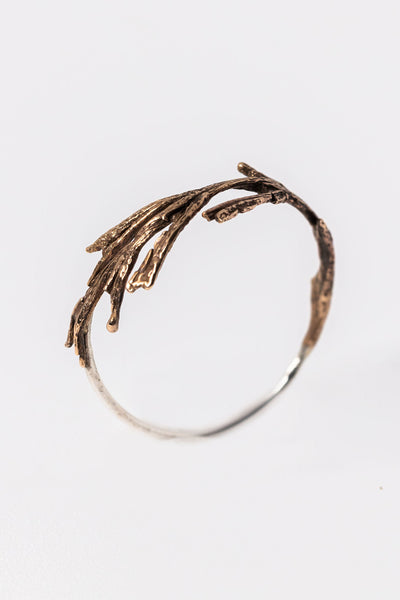 Bottom side view of bronze and silver twig ring, handcrafted jewelry made from plants, by Alison Jefferies for J'Adorn Designs