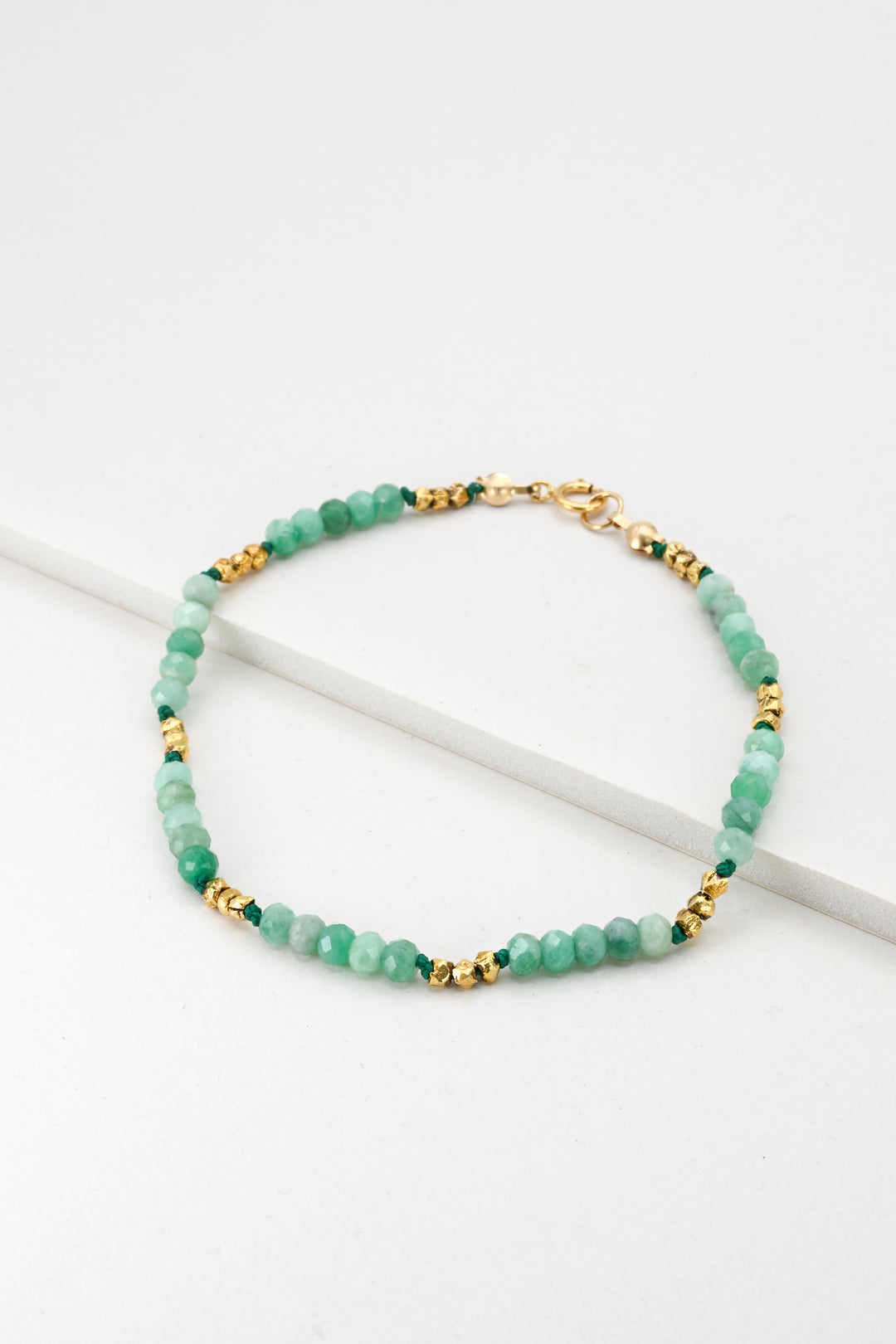 Hand-strung green emerald beaded bracelet with faceted gold vermeil spacer beads and a gold clasp