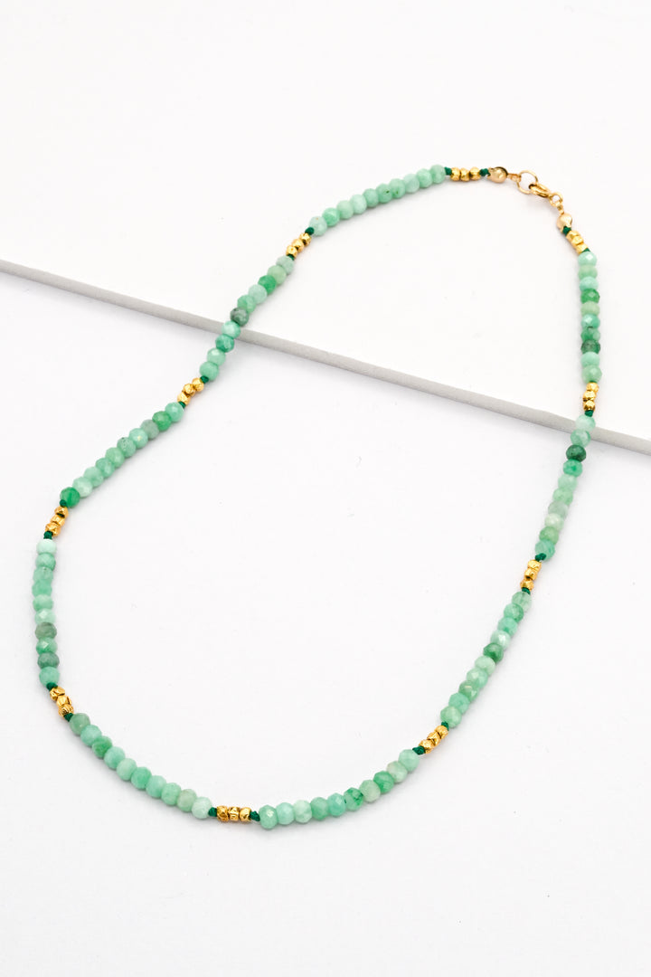 Emerald and gold vermeil beaded necklace on a white background.