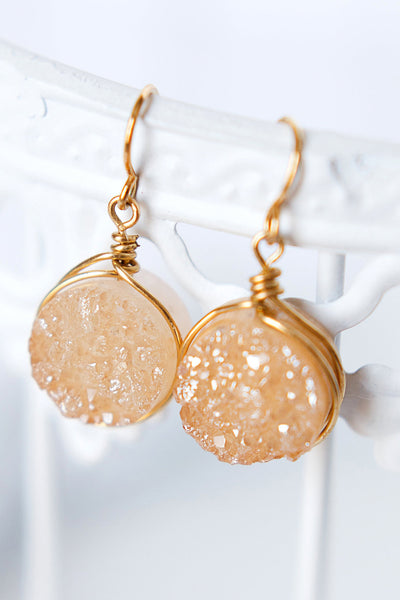 Golden champagne colored round druzy drop earrings with gold wires. Handcrafted druzy jewelry by designer Alison Jefferies of J'Adorn Designs