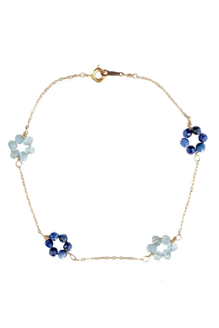 Delicate gold chain and blue gemstone flower bracelet. Aquamarine and kyanite daisy chain bracelet by jewelry artisan Alison Jefferies of J'Adorn Designs