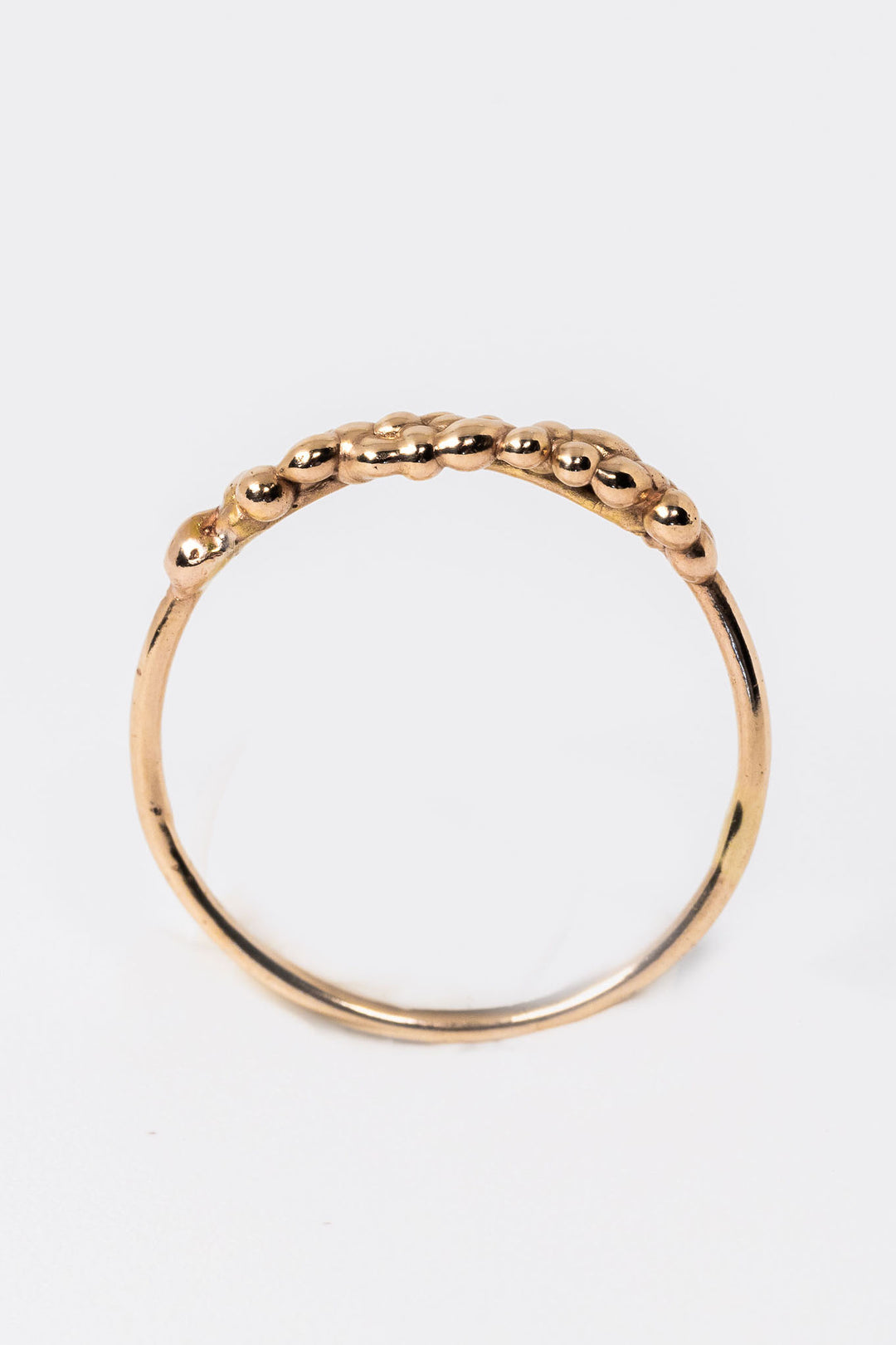 Standing side view of 14k yellow gold stacking ring with organic textured top by Alison Jefferies for J'Adorn Designs jewelry