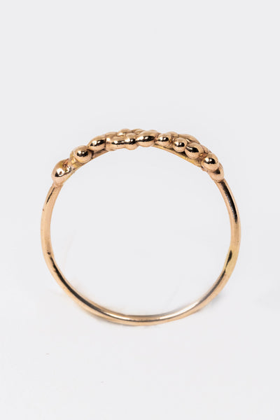 Standing side view of 14k yellow gold stacking ring with organic textured top by Alison Jefferies for J'Adorn Designs jewelry