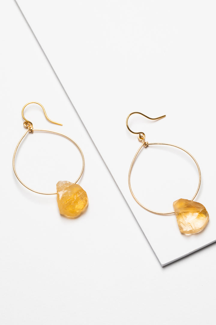 One pair of gold hoop earrings for sale with rough citrine teardrops. 14k gold filled modern hoop earrings for fashion or a jewelry gift idea. Artisan jewelry and luxury bridal accessories handmade in Maryland by Alison Jefferies of J'Adorn Designs.