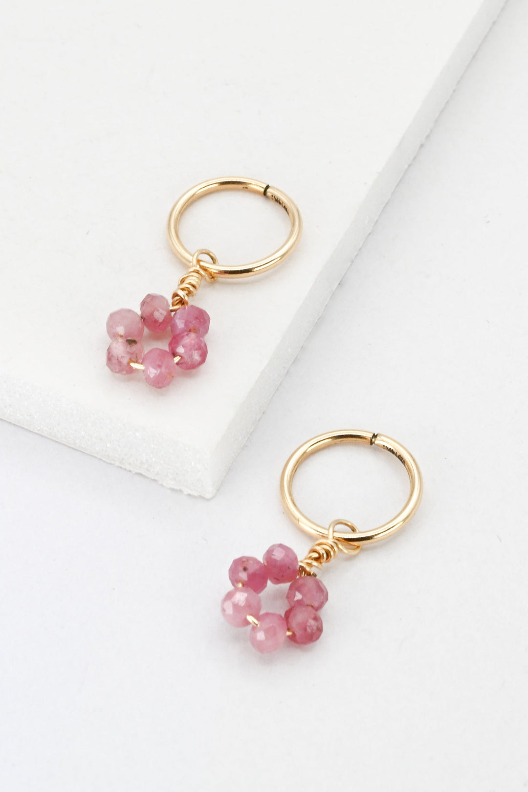 Tiny gold hoop earrings with pink tourmaline flower charms by J'Adorn Designs