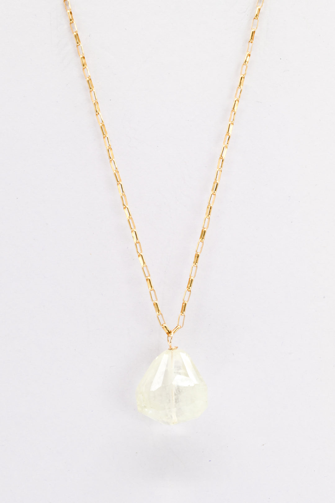 Gold necklace with a light green aquamarine teardrop pendant