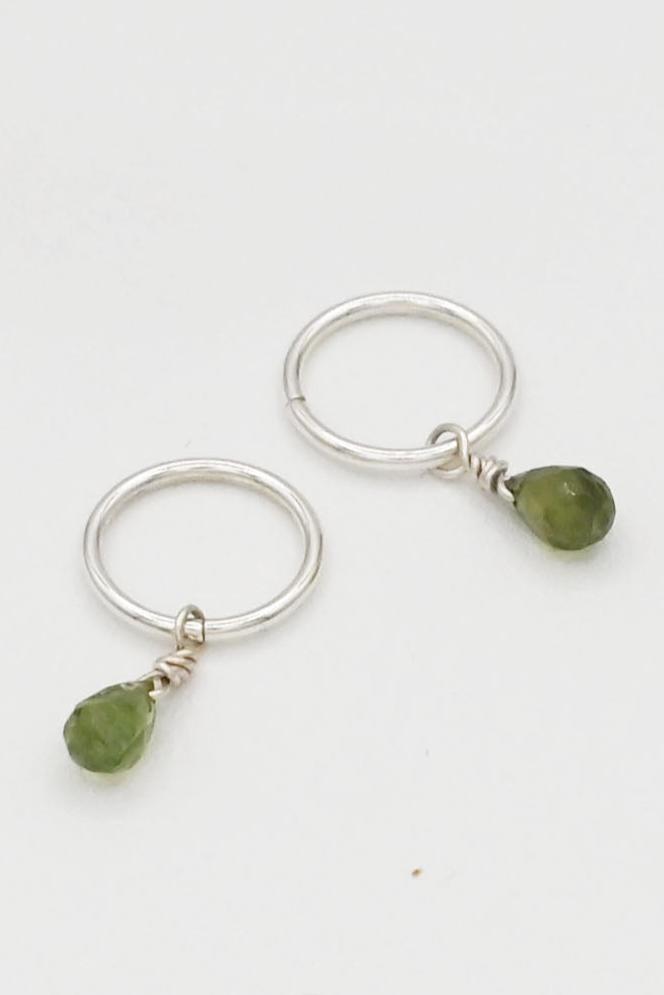 Sterling silver 10 mm seamless huggie hoop earrings with small green sapphire teardrop charms